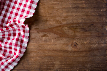 Red and White Checkered Tablecloth on Rustic Wooden Surface