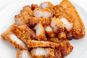 Crispy Fried Pork Belly Pieces on White Plate Delicious Snack