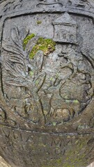  Historic gravestone with intricate carvings and engravings displayed in the open area of the Chapel of St. Catherine, Old Goa