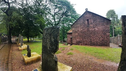  Exterior view of the historic Chapel of St. Catherine, showcasing medieval architecture on a cloudy, rainy day
