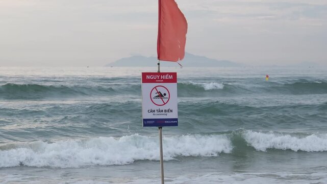 vietnam danang 09.04.2025 beach people Danger warning beach
