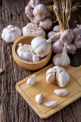 Fresh Garlic Bulbs and Cloves on Wooden Surface with Natural Light