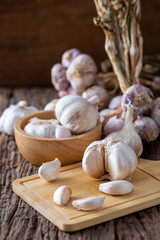 Fresh Garlic Bulbs on Wooden Cutting Board and Natural Background