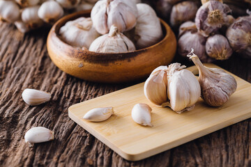 Fresh Garlic Bulbs and Cloves on Wooden Table with Rustic Background
