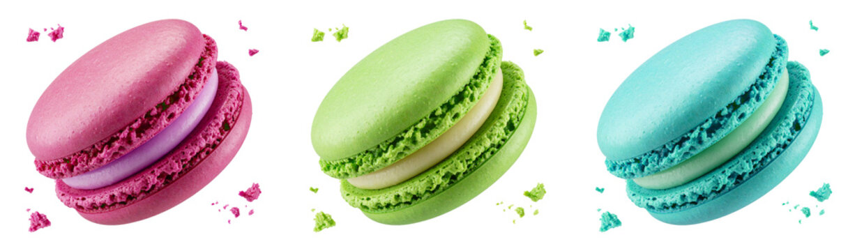 set of colorful flying macarons  with crumbs isolated on white background