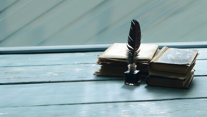 Old books with quill pen ad vintage inkwell on woode desk, retro history and lterature concept