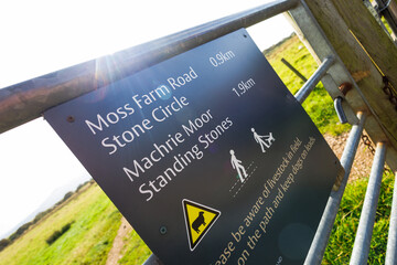 Sign marking Machrie Moor on the Isle of Arran, Scotland, surrounded by natural moorland landscape