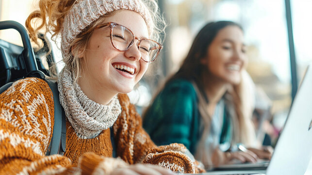 Two Young Women Smiling While Studying Together in a Bright Modern Caf? with Laptops Open