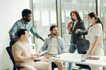 Diverse group of business team collaborating in modern office with dog