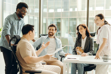 Diverse business team discussing work in modern office with dog