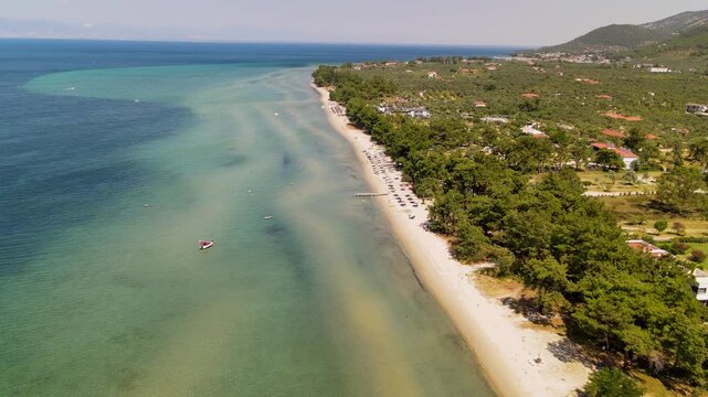 Prinos beach and sea, Thassos Island, Greece. Amazing beach with clear blue water. Aerial panoramic drone view from above, top view from drone. Summer holidays Europe
