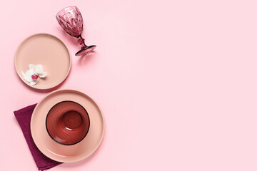 Beautiful table setting with orchid flower on pink background