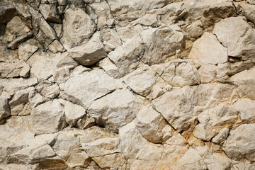 Rough natural stone surface with detailed textures and earthy tones, ideal for geological illustrations, mineral studies, and nature-inspired designs.