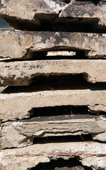 Stack of old concrete slabs with cracks and rough texture