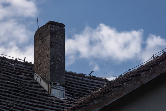 CHIMNEY ON THE ROOF - Brick architectural element of an old house
