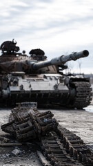 destroyed houses and a military tank on the street of Kiev during the war in Ukraine