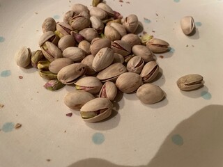 pistachio nuts on a wooden table