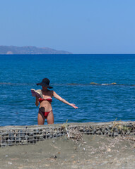 Woman in Red Swimsuit Relaxing and Reading on Cyprus Beach
