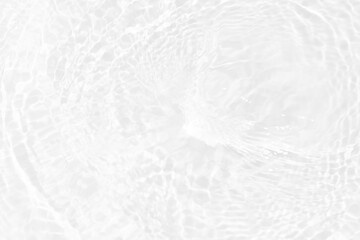 White water with ripples on the surface. Defocus blurred transparent white colored clear calm water surface texture with splashes and bubbles. Water waves with shining pattern texture background.
