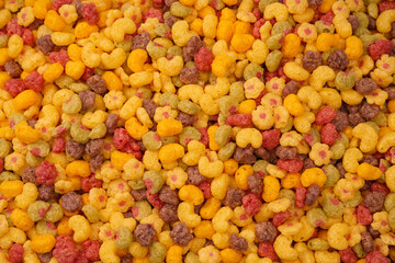 Sweet crunchy cornflakes as a background. Top view.