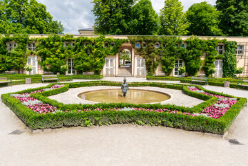 Beautiful garden with fountain, flowers and green hedges in Mirabell Palace Gardens