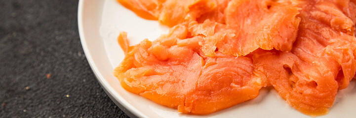 Smoked salmon fish seafood portion size natural product tasty snack fresh delicious gourmet food background on the table rustic top view copy space pescetarian diet
