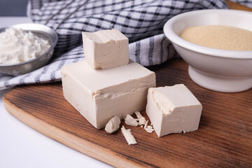 dry and compressed yeast on a wooden board