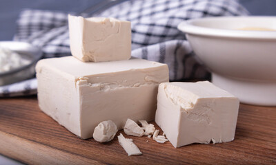 dry and compressed yeast on a wooden board
