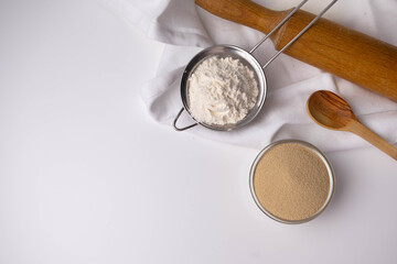 dry yeast in a glass bowl on a white background