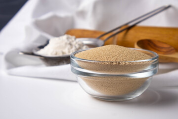 dry yeast in a glass bowl on a white background