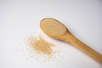 Dry yeast on wooden spoon — baking ingredient