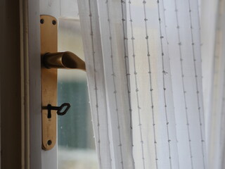 Gold handle on a door with a keyhole