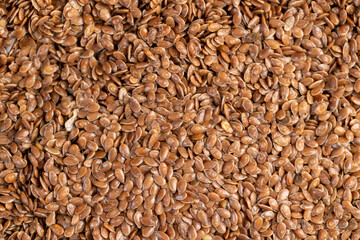 wet flax seeds are used to produce food or linseed oil or germinate for dietary nutrition, covered with drops of water brown flax seeds