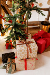  Gift boxes under the Christmas tree in the house decorated with festive Christmas toys