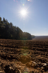 a plowed agricultural field with fertile soil prepared for sowing a new crop of plants, plowed soil...