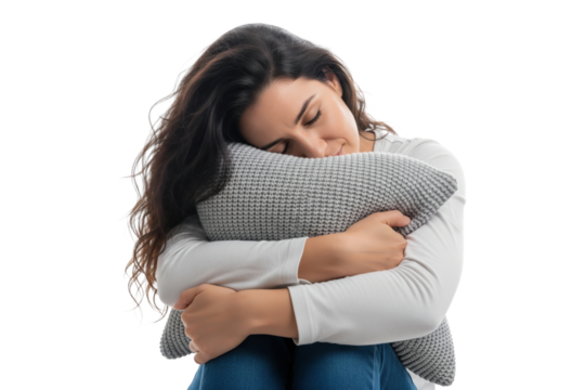 Peaceful woman holding and hugging a pillow to her chest