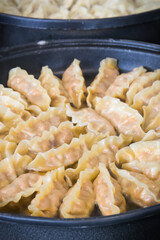 Fried dumplings on frying pan. Traditional food