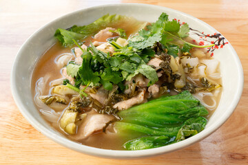 angle view rice noodles with pickled mustard greens and lean pork at horizontal composition
