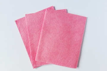 Three pink microfiber cleaning cloth. White background.