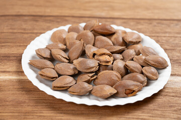 angle view dish of apricot kernels