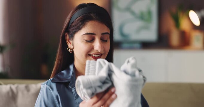 Smell, cleaning and clothes with woman on sofa for laundry, maintenance and fresh linen. Domestic chores, fabric softener and cotton scent with person in living room of home for housekeeping