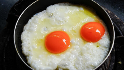 Two fried eggs in a pan