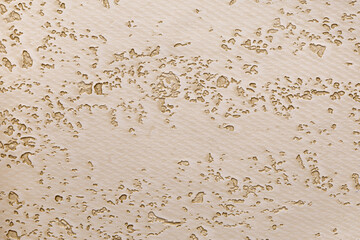 Soft wallpaper with plaster smeared across the surface with holes and indentations