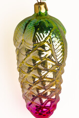 Vintage glass toy from the Soviet era in the shape of a pine cone on a light background
