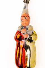 An artistic glass toy from the Soviet era in the shape of a harlequin doll with peeling paint on...