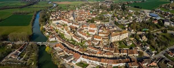 Aerial panoramic view around the old town and city Pesmes in France on a sunny afternoon