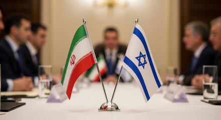 The flags of Iran and Israel stand on a conference table during a diplomatic meeting. Represents international relations, diplomacy, negotiation, politics, and geopolitical issues.