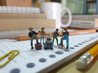 Mini toy of action figure at table with blurred background. Miniature diorama photography concept...