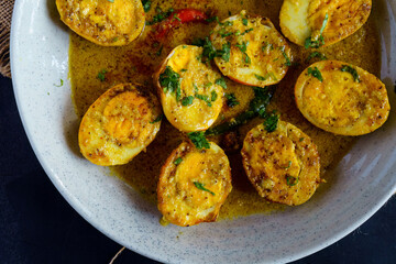 Traditional Bengali egg malaicurry or dim malaikari, boiled eggs cooked in rich coconut milk gravy with spices, authentic Indian curry from Bengal cuisine served with steamed rice as festive meal
