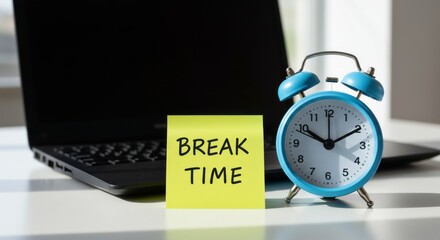 A blue alarm clock signals break time, next to a sticky note and laptop.